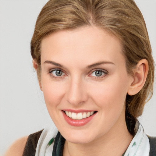 Joyful white young-adult female with medium  brown hair and blue eyes