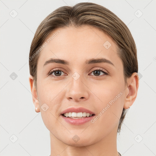 Joyful white young-adult female with short  brown hair and grey eyes