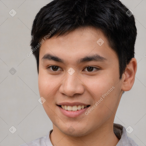 Joyful asian young-adult male with short  brown hair and brown eyes