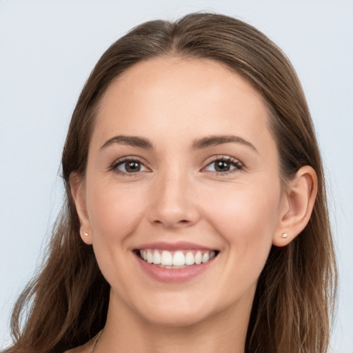 Joyful white young-adult female with long  brown hair and grey eyes