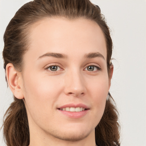 Joyful white young-adult female with long  brown hair and grey eyes