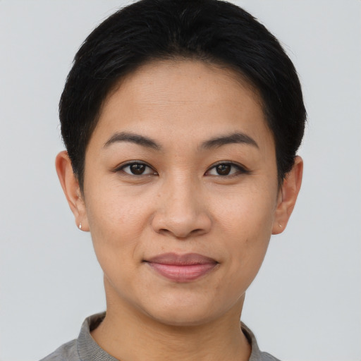 Joyful asian young-adult female with short  brown hair and brown eyes