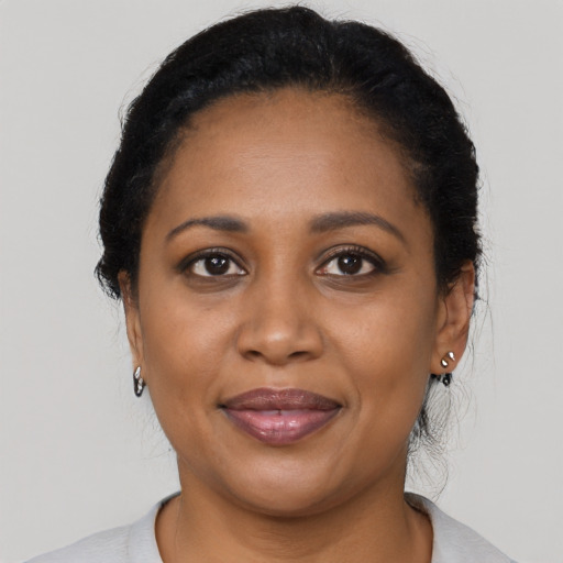 Joyful black adult female with medium  black hair and brown eyes