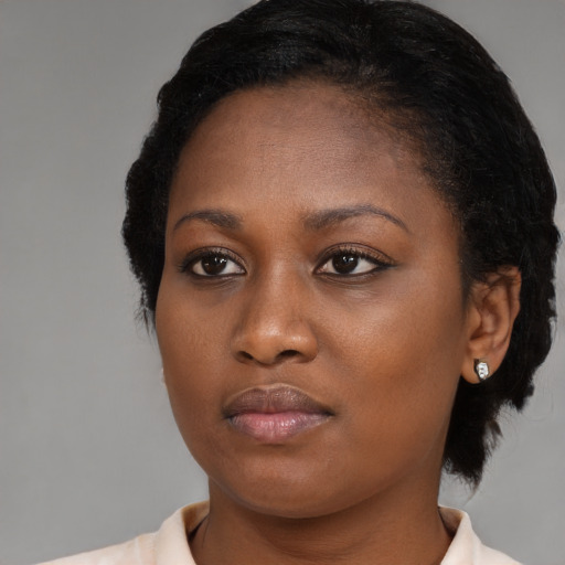 Neutral black young-adult female with medium  brown hair and brown eyes
