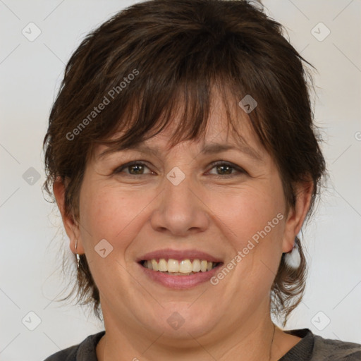 Joyful white adult female with medium  brown hair and brown eyes