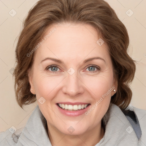 Joyful white adult female with medium  brown hair and grey eyes