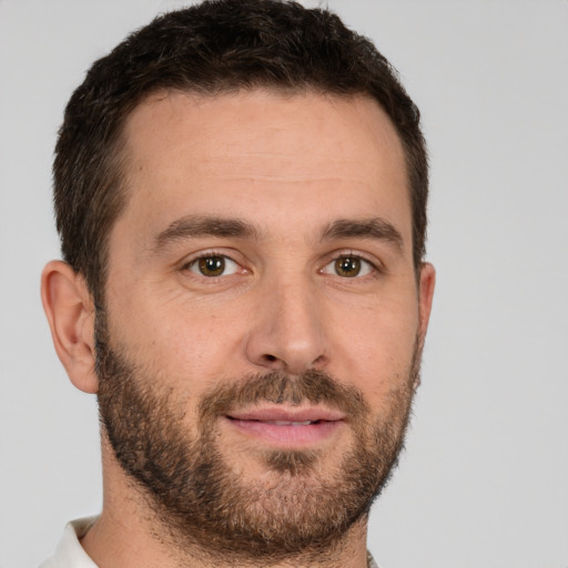 Joyful white young-adult male with short  brown hair and brown eyes