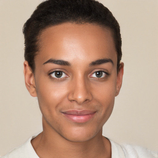 Joyful latino young-adult female with short  brown hair and brown eyes