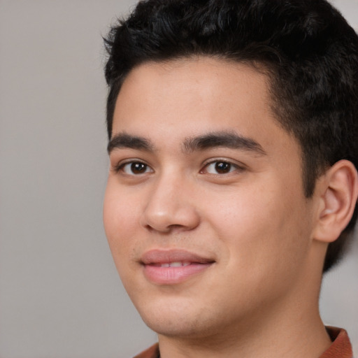 Joyful white young-adult male with short  black hair and brown eyes