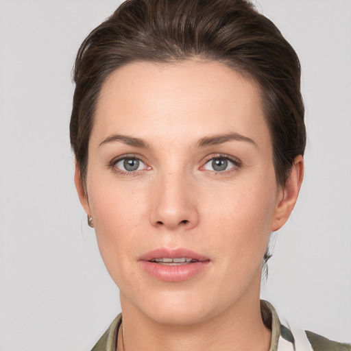 Joyful white young-adult female with medium  brown hair and grey eyes