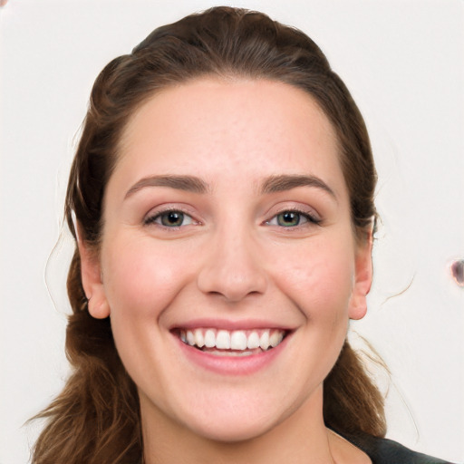 Joyful white young-adult female with long  brown hair and grey eyes