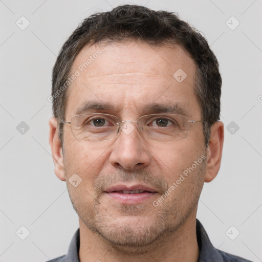 Joyful white adult male with short  brown hair and brown eyes