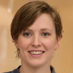 Joyful white young-adult female with medium  brown hair and grey eyes