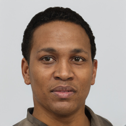 Joyful black adult male with short  black hair and brown eyes