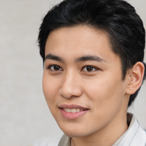Joyful latino young-adult male with short  brown hair and brown eyes