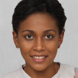 Joyful black young-adult female with short  brown hair and brown eyes