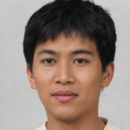 Joyful asian young-adult male with short  black hair and brown eyes