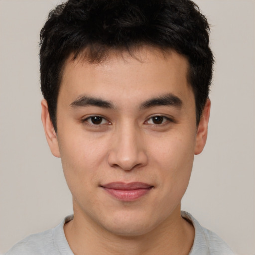 Joyful asian young-adult male with short  brown hair and brown eyes