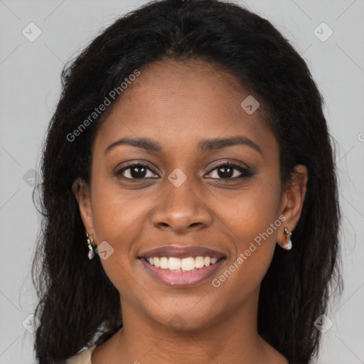 Joyful black young-adult female with long  brown hair and brown eyes