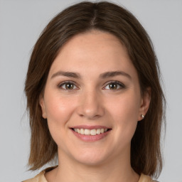 Joyful white young-adult female with medium  brown hair and grey eyes