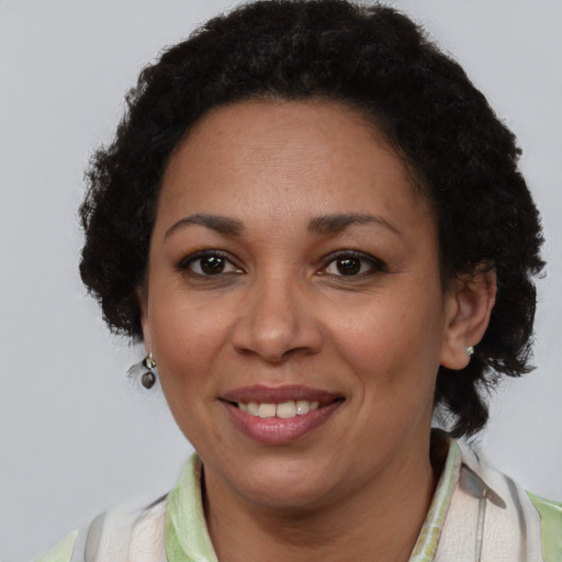 Joyful latino adult female with short  brown hair and brown eyes