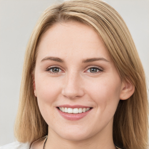 Joyful white young-adult female with long  brown hair and blue eyes