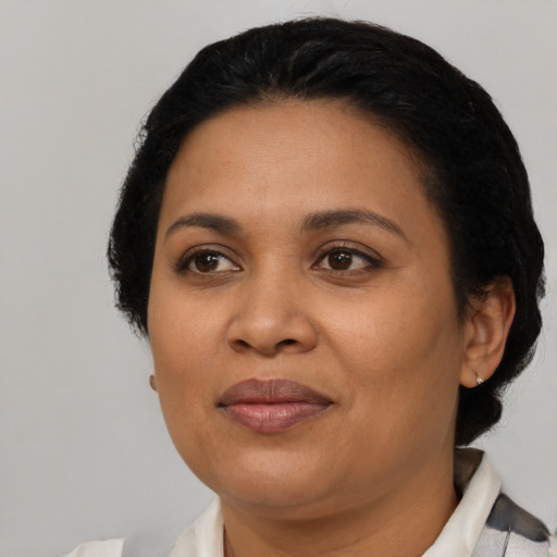 Joyful latino adult female with short  black hair and brown eyes
