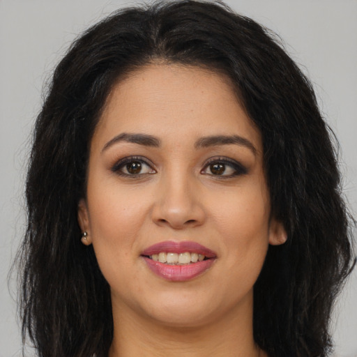 Joyful latino young-adult female with long  brown hair and brown eyes