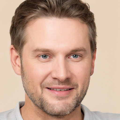 Joyful white adult male with short  brown hair and grey eyes