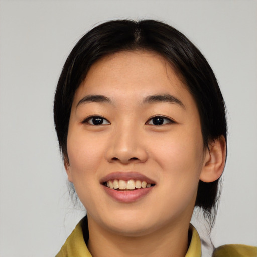 Joyful asian young-adult female with medium  black hair and brown eyes