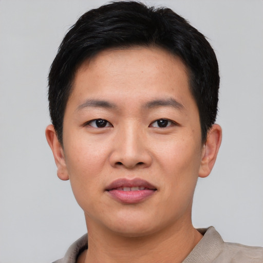 Joyful asian young-adult male with short  black hair and brown eyes