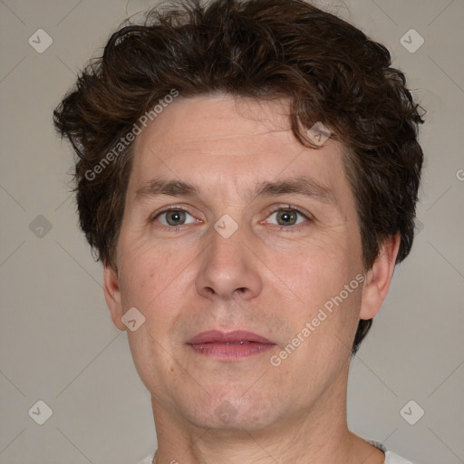 Joyful white adult male with short  brown hair and grey eyes