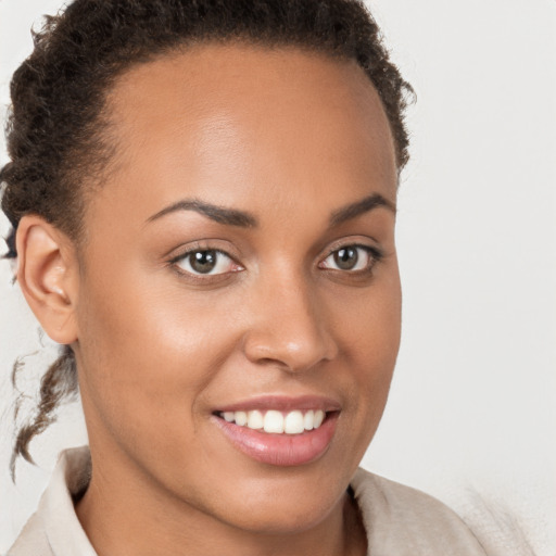 Joyful latino young-adult female with short  brown hair and brown eyes