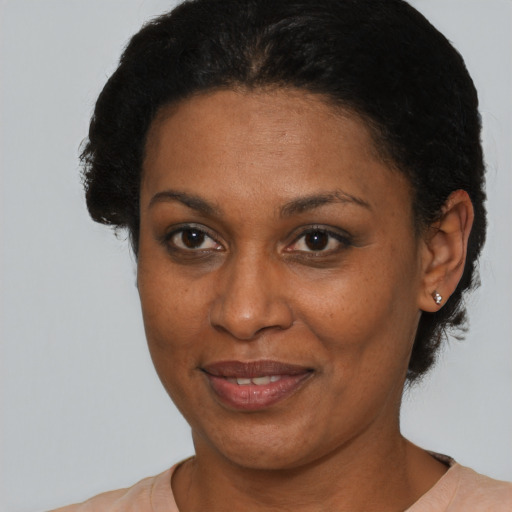 Joyful black adult female with short  brown hair and brown eyes