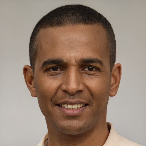 Joyful latino young-adult male with short  brown hair and brown eyes
