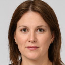 Joyful white adult female with long  brown hair and grey eyes