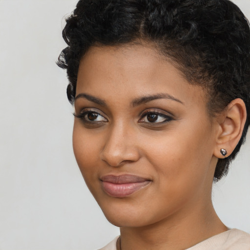 Joyful latino young-adult female with short  brown hair and brown eyes