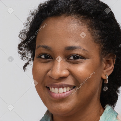 Joyful black young-adult female with short  brown hair and brown eyes