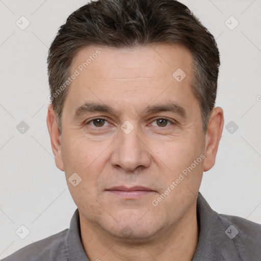 Joyful white adult male with short  brown hair and brown eyes