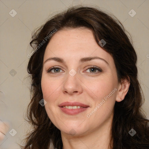 Joyful white adult female with long  brown hair and brown eyes