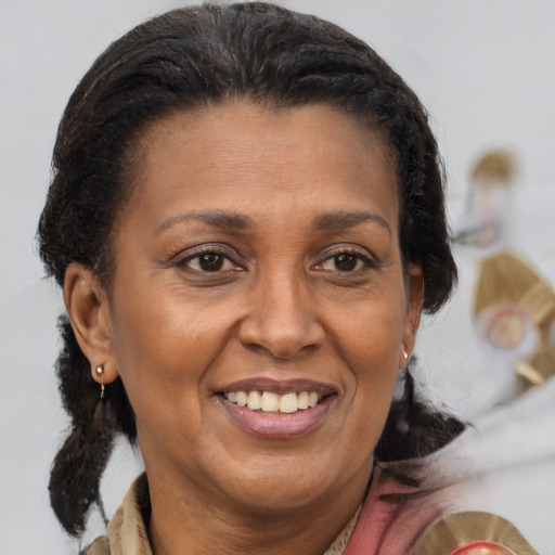Joyful black adult female with medium  brown hair and brown eyes