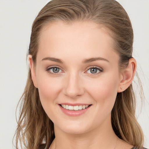 Joyful white young-adult female with long  brown hair and grey eyes