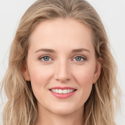 Joyful white young-adult female with long  brown hair and blue eyes