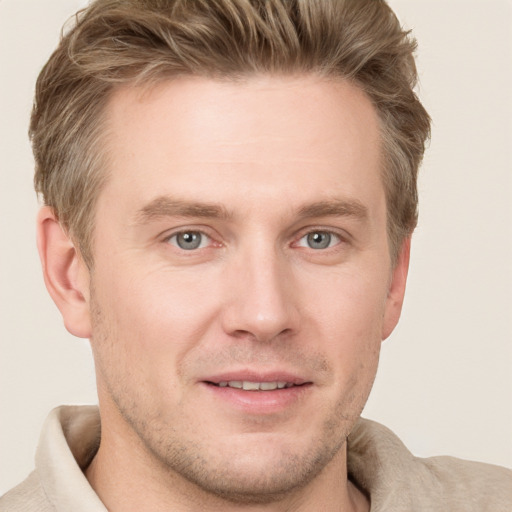 Joyful white adult male with short  brown hair and grey eyes