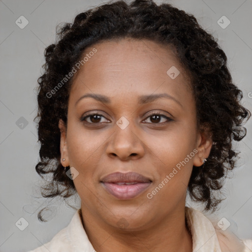 Joyful black adult female with medium  brown hair and brown eyes