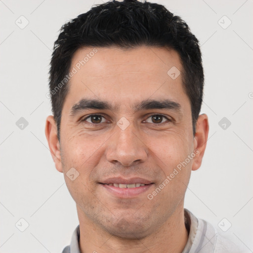 Joyful white young-adult male with short  black hair and brown eyes