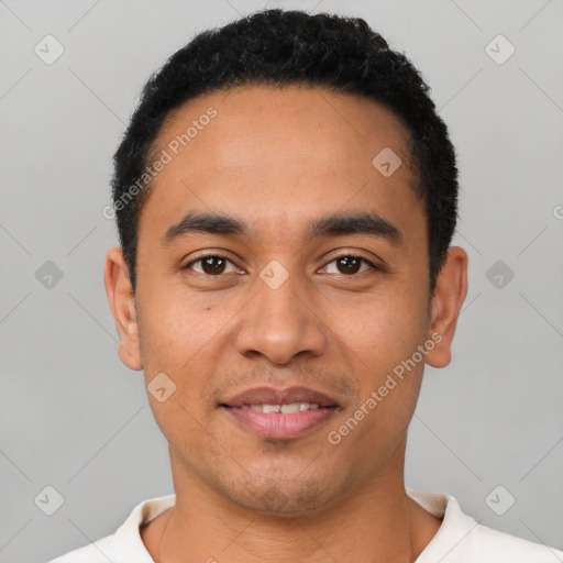 Joyful latino young-adult male with short  black hair and brown eyes