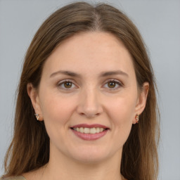 Joyful white young-adult female with long  brown hair and grey eyes