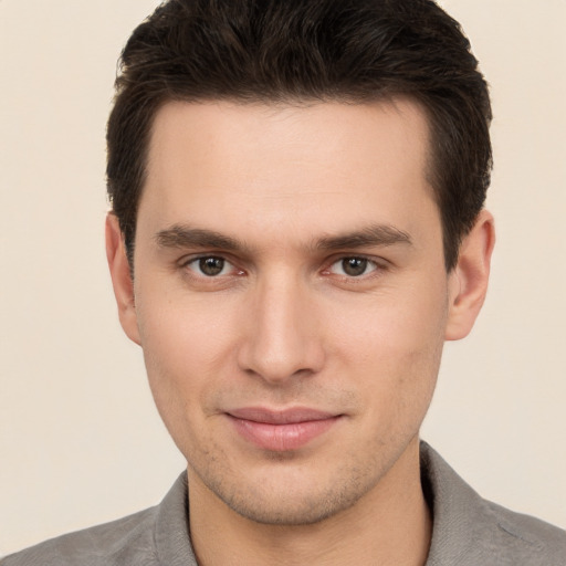 Joyful white young-adult male with short  brown hair and brown eyes