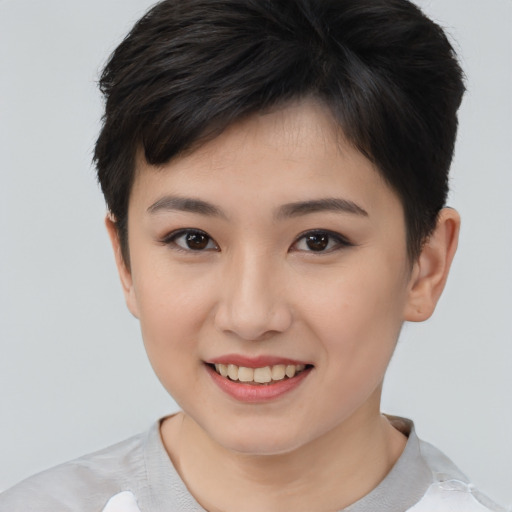 Joyful asian young-adult female with short  brown hair and brown eyes